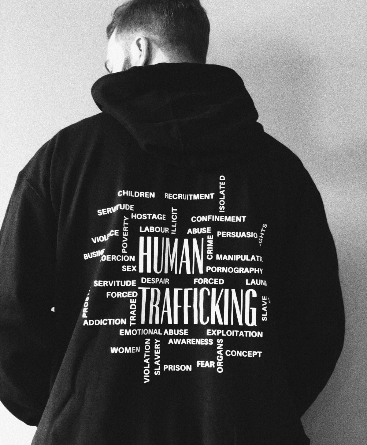 man with hoodie that says human trafficking