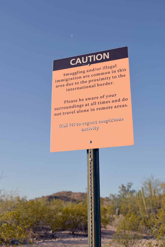 Sign posted at U.S. border cautioning people that smuggling is common in the area.